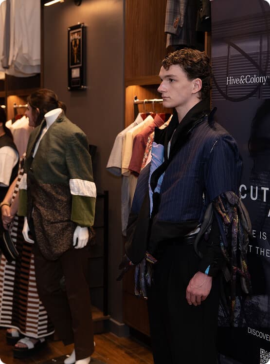 Male model wearing a deconstructed navy jacket at the A Cut Above showcase.