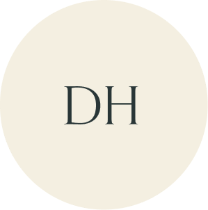 Cream circular monogram with DH initials.