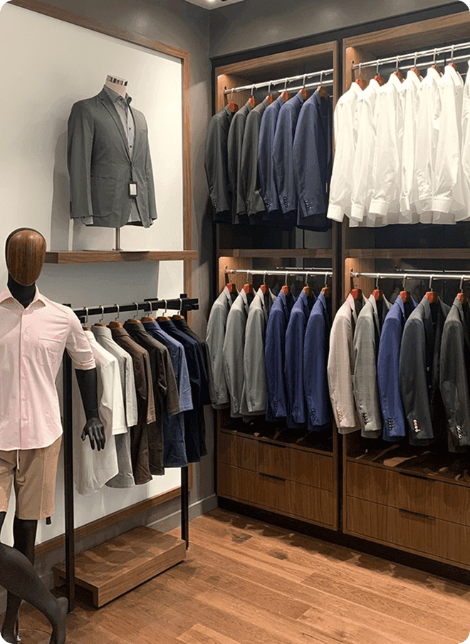 Aventura showroom with a mannequin and rows of jacket racks.