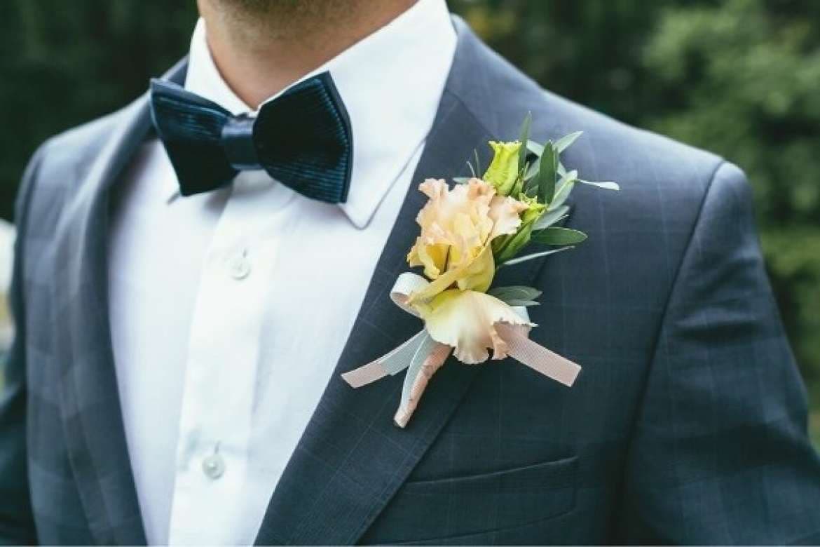 Groom wearing a tailored suit for a wedding.