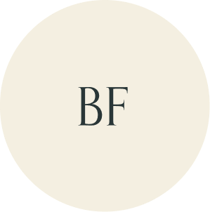 Cream circular monogram with BF initials.