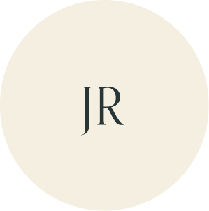 Cream circular monogram with JR initials.