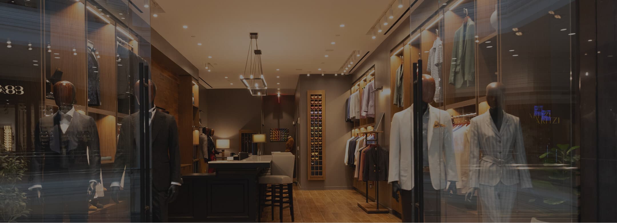 Hive & Colony storefront with mannequins and tailored suits.