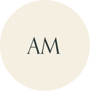 Cream circular monogram with AM initials.