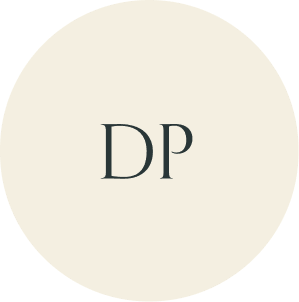 Cream circular monogram with DP initials.