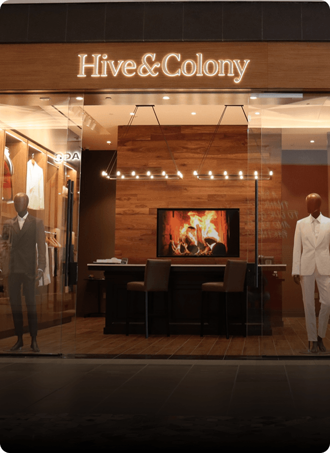 Hive & Colony storefront with mannequins and a fireplace screen.