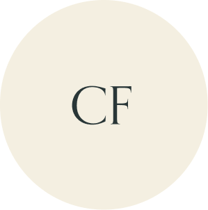 Cream circular monogram with CF initials.