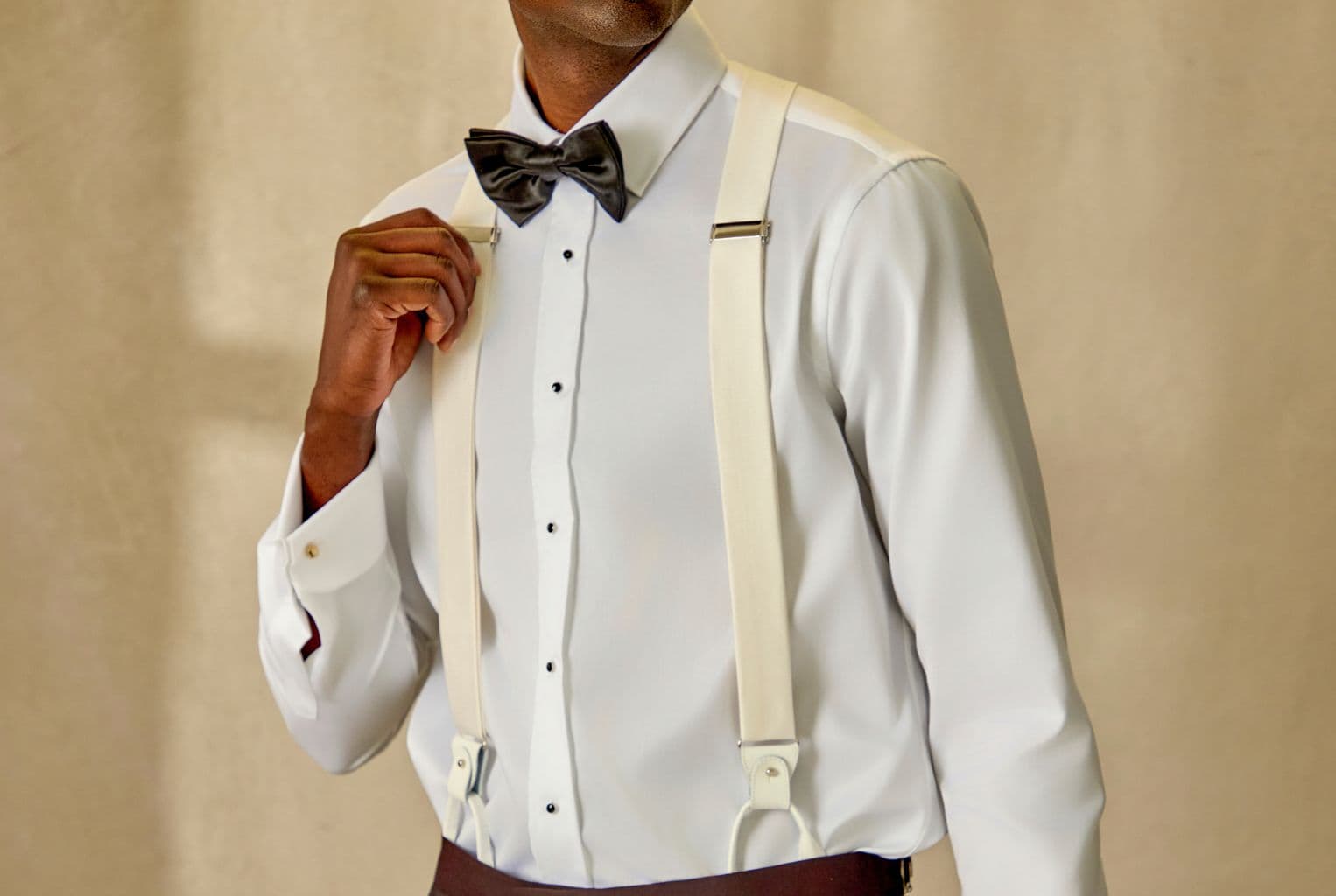 Tailored suit styled with suspenders.