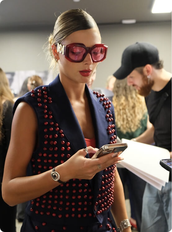 Fashion students selecting garments and fabrics from clothing racks during the Marangoni collaboration.