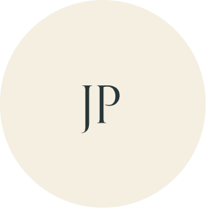 Cream circular monogram with JP initials.