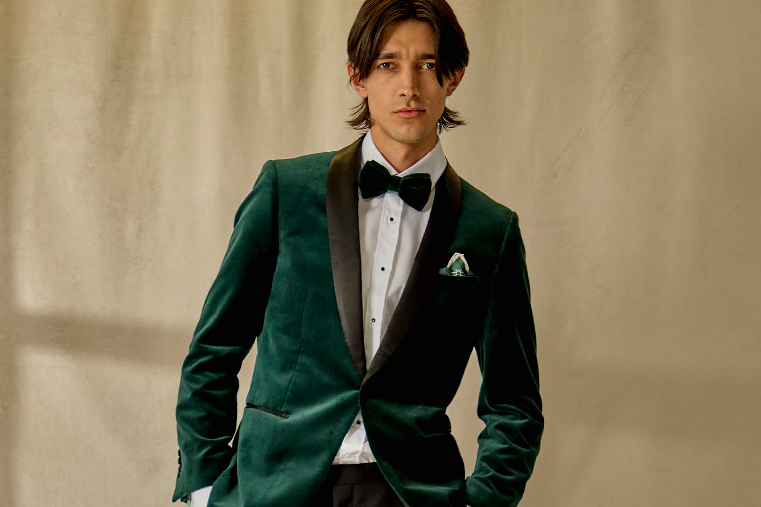 Man wearing a green velvet tuxedo with black satin lapels.
