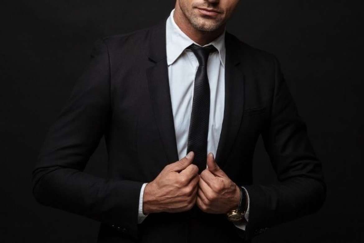 Man wearing a suit with polished formal styling.