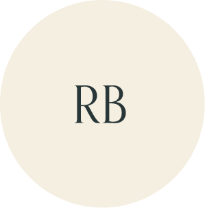 Cream circular monogram with RB initials.