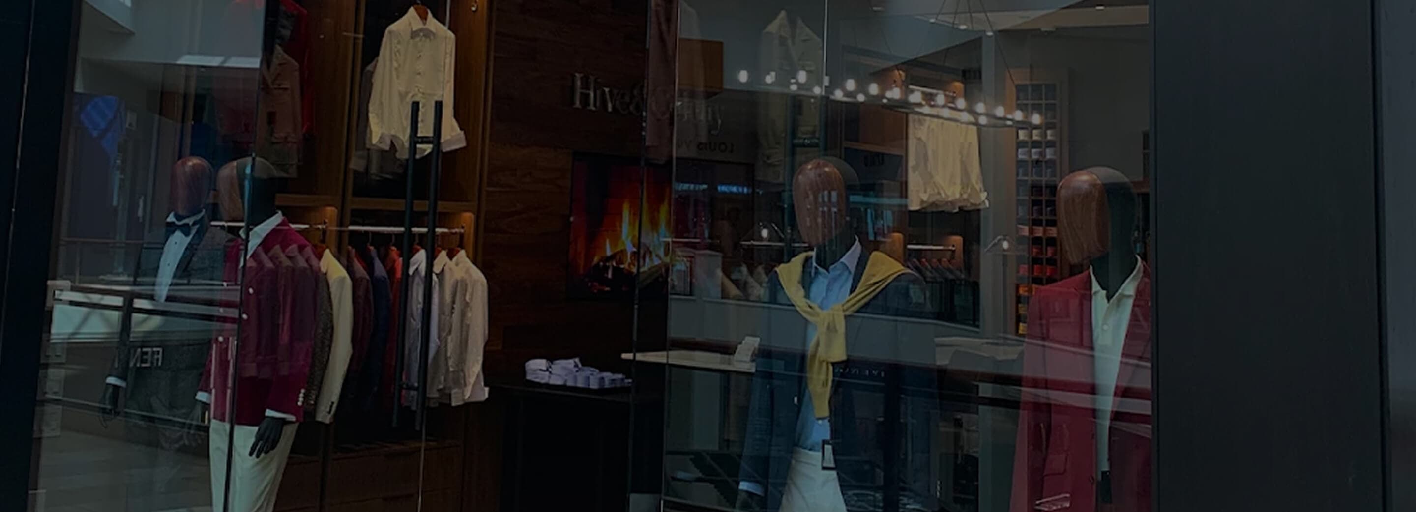 Hive & Colony storefront with mannequins and tailored menswear displays.