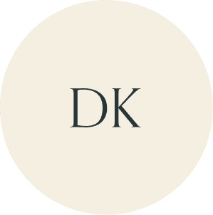 Cream circular monogram with DK initials.
