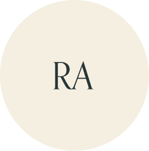 Cream circular monogram with RA initials.