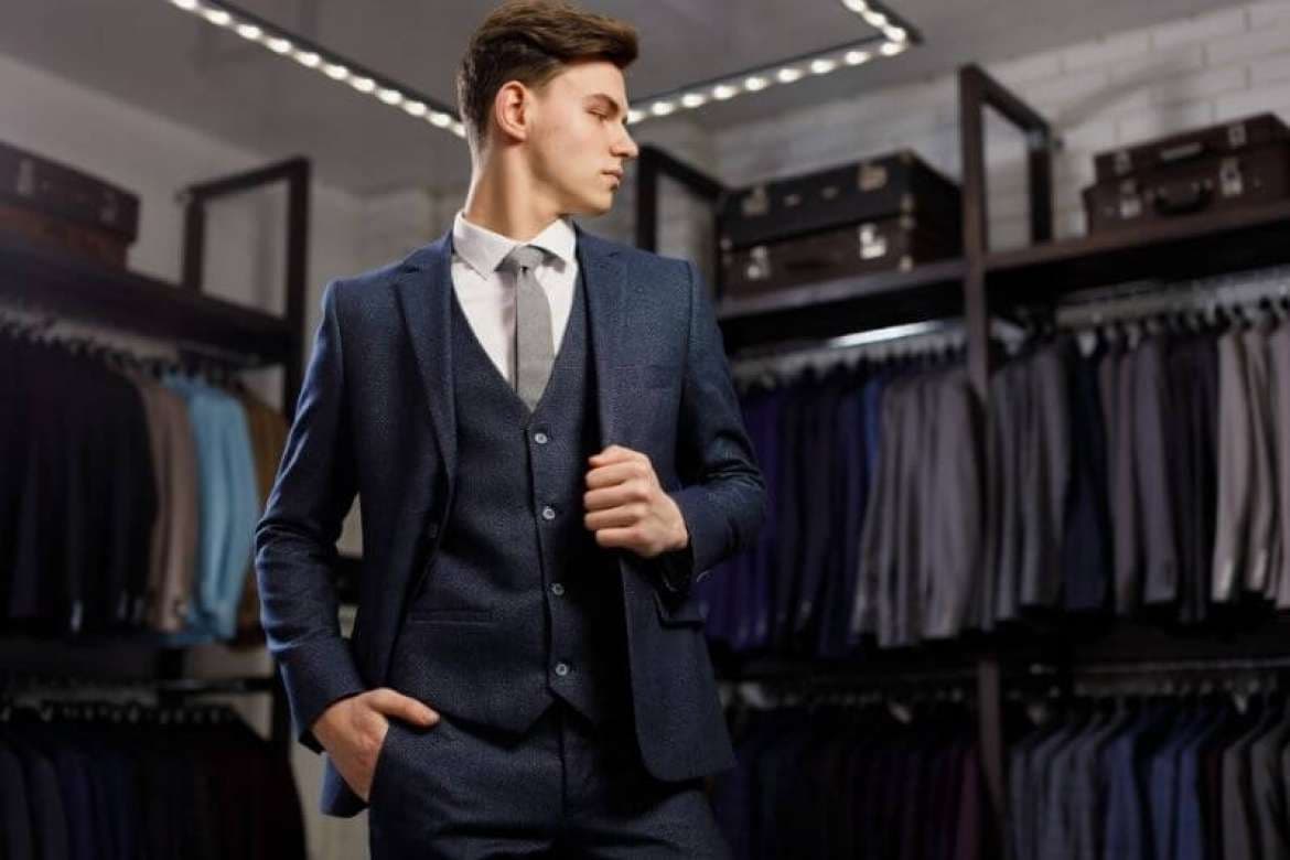 Tailor measuring a client for a custom suit.
