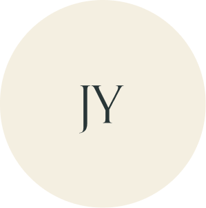 Cream circular monogram with JY initials.