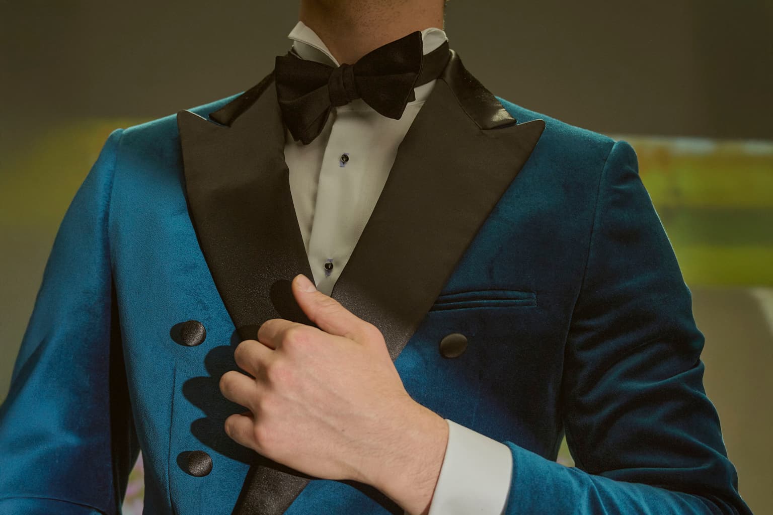 Close-up of a blue velvet tuxedo with black satin lapels.